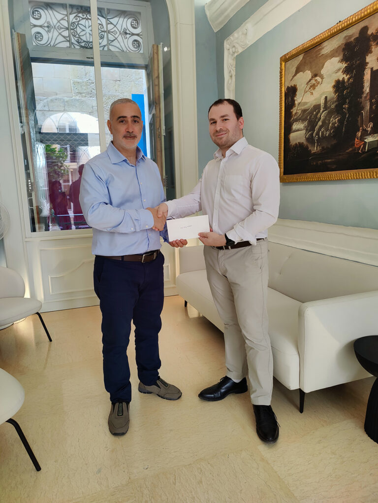 Dr Warren Ciantar presenting MTCV donation to Mr Max Borg Bonello